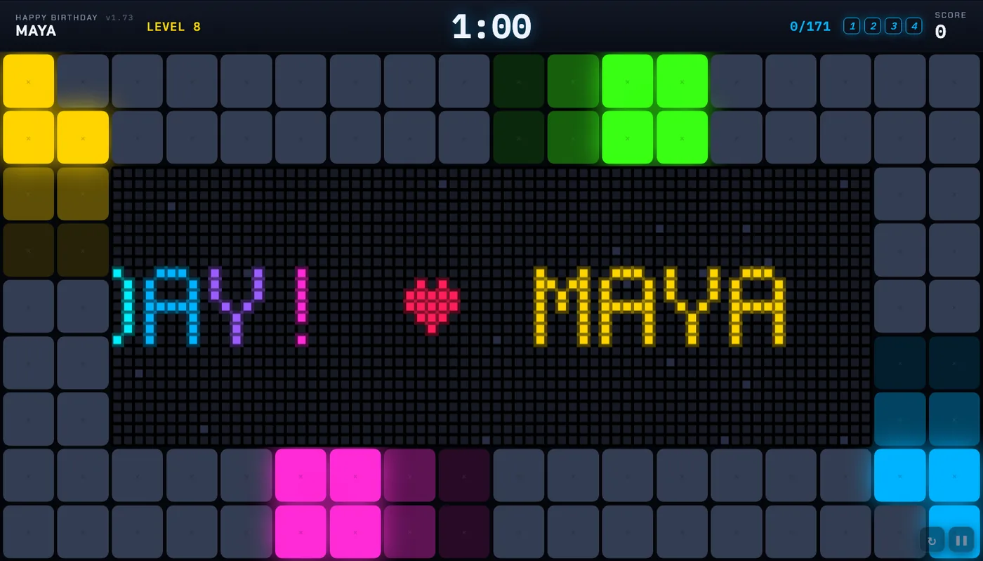 The birthday parade: an LED sign across the floor reading DAY! heart MAYA in pixel letters, coloured tiles marching round the edge